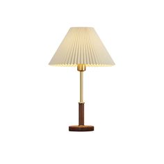 a lamp with a wooden base and white shade on it's side, against a white background