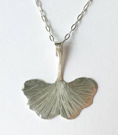 "Hand forged Sterling silver or brass etched and engraved Artisan Gingko leaf necklace measuring 1\"x1\" suspended on a sterling silver or gold filled chain." Unique Etched Sterling Silver Necklace, Etched Sterling Silver Pendant Necklace, Silver Etched Nature-inspired Necklaces, Nature-inspired Silver Etched Necklaces, Handmade Leaf-shaped Sterling Silver Jewelry, Handmade Sterling Silver Leaf-shaped Jewelry, Etched Silver Nature-inspired Jewelry, Sterling Silver Etched Necklace For Gift, Etched Nature-inspired Silver Jewelry