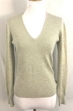 a white mannequin wearing a gray sweater