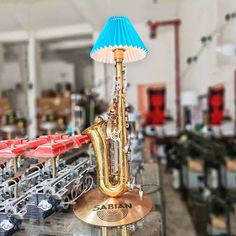 an assortment of musical instruments sitting on top of a glass table in a room filled with other items