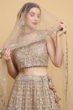 Festive earthy beige lehenga with an attached cancan and mirror and thread embroidery. Comes with a padded blouse and a dupatta. - Aza Fashions Beige Lehenga, Satin Lehenga, Net Blouses, Saree Gown, Padded Blouse, Net Lehenga, Contemporary Wedding, Eid Collection, Satin Color