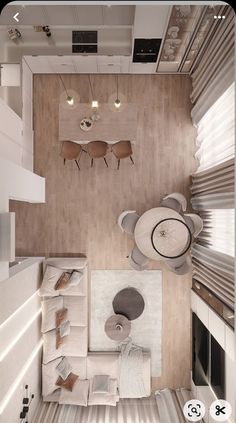 an overhead view of a living room and dining area in a house with wood flooring