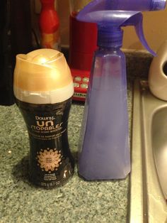 a bottle of cleaner next to a soap dispenser on a kitchen counter