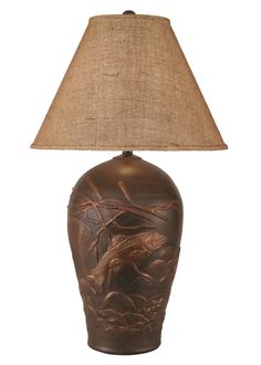 a lamp with a bird on it and a burluck shade over the base