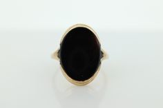 This is a super unique ring. Will work great for women and men alike. Excellent Pinkie ring.  Onyx bezel set. Made in the 30s. Condition: Shows minimal signs of wear. Has not been polished. Onyx has some scratches that show in the light. Details: 10k Yellow Gold Marked 10k  12mm by 16mm Oval Onyx 3mm rise sz 5 Antique Oval Signet Ring With Polished Finish, Victorian Oval Signet Ring With Polished Finish, Classic 14k Gold Signet Ring With Cabochon, Vintage Domed Rings With Polished Finish, Art Deco Oval Cabochon Rings, Vintage Signet Ring With Cabochon For Anniversary, Art Deco Hallmarked Ring With Oval Cabochon, Vintage Cabochon Signet Ring For Anniversary, Classic Engraved Cabochon Ring