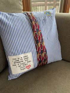 a pillow with a tie on it sitting on a couch