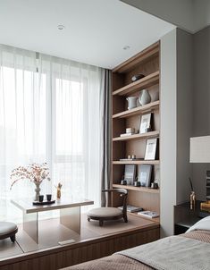 a bed room with a neatly made bed and a book shelf next to a window