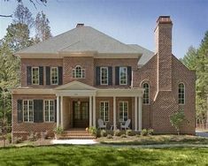 a large brick house with lots of windows