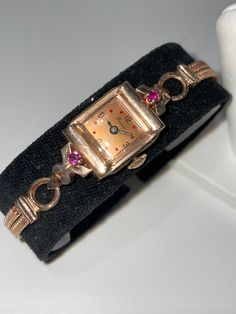 "Fabulous vintage solid 14 kt rose gold ladies mechanical wristwatch with matching 14 kt rose gold double snake band. The dial is also rose gold colored making this ensemble absolutely gorgeous. Custom fit for a 6.25\" wrist. This Art Deco watch has a mechanical 17 jewel hand winding movement that is in good working condition and keeps time very well. The watch case is accented with a ruby on each lug. A beautiful working vintage timepiece ." Art Deco Watches Ladies, Art Deco Watch, Antique Costume Jewelry, Simple Watches, Vintage Timepiece, Bird Baths, Snake Bracelet, Women Wrist Watch, Watch Case