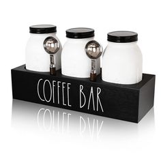 three jars with lids are sitting on a black box that says coffee bar, colette d'av