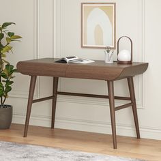 a wooden table with a plant on it in front of a white wall and floor