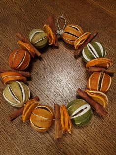 a bracelet made out of dried fruits and cinnamons on a wooden table with a metal chain