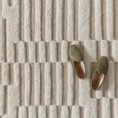 two pairs of shoes sitting on top of a rug