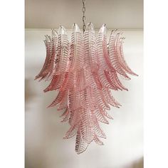 a pink chandelier hanging from a ceiling