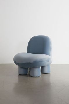 a blue chair sitting on top of a cement floor