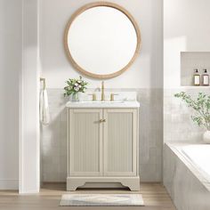 a bathroom with a sink, mirror and bathtub