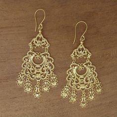 Possessing a real beauty these chandelier earrings from Bali are designed by Desi Antari. She works with sterling silver handcrafting each earring from wire and dot work that is bathed in 18k gold.