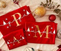 two personalized christmas towels on top of a bed next to other holiday decorations and ornaments