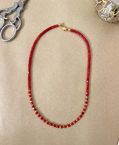 Handmade Red Coral Gemstone with Gold Beads Necklace, a captivating piece that exudes a combination of vibrant energy and timeless sophistication.  This necklace showcases the natural beauty of red coral gemstones, carefully handcrafted alongside shimmering gold beads. The warm glow of the gold perfectly complements the fiery intensity of the coral, creating a harmonious balance that catches the eye. Its adjustable length allows for a customized fit, while a secure clasp ensures ease of wear and peace of mind. Whether you're attending a special occasion or looking to add a bold statement to your everyday ensemble, the Handmade Red Coral Gemstone with Gold Beads Necklace is the ideal choice. Its unique combination of fiery red coral and gleaming gold beads makes it a standout piece that emb Red Gemstone Beaded Spiritual Bracelets, Red Spiritual Beaded Bracelets With Gemstone Beads, Red Spiritual Gemstone Beaded Bracelets, Spiritual Red Gemstone Beaded Bracelets, Red Spiritual Jewelry With Gemstone Beads, Red Beaded Jewelry For Gifts, Red Jewelry With Colorful Beads For Gift, Adjustable Rondelle Beaded Necklaces As Gifts, Elegant Red Gemstone Beads