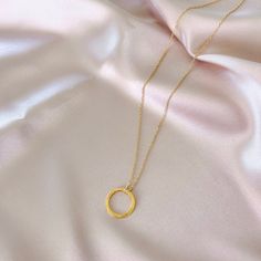 Our signature gold circle necklace is designed for layering over any necklace in our collection. Handmade, tarnish resistant 14k gold plated chain. Adjustable between 16"-18". Gold Charm Necklace With Round Pendant And Cable Chain, Dainty Gold Chain Round Necklaces, Dainty Round Gold Chain Necklace, Gold Circular Jewelry With Adjustable Chain, Dainty Gold Chain Round Charm Necklace, 14k Gold Filled Round Cable Chain Necklaces, 14k Gold Filled Round Cable Chain Necklace, Everyday Circular 14k Gold Filled Jewelry, 14k Gold-filled Cable Chain Necklaces