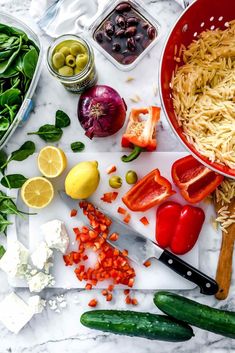 the ingredients for this dish include tomatoes, olives, peppers, and pasta