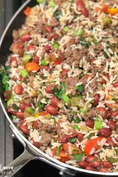 a pan filled with rice, beans and meat