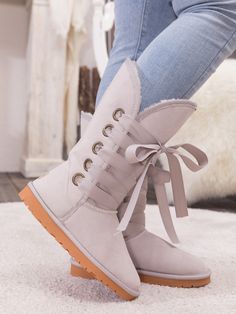 Stay warm in chic, eye-catching style when you pull on these genuine suede boots featuring plush faux fur-lining and bold ribbon laces. 1'' heel 11.8'' shaft 14.2'' circumference Pull-on Suede upper Faux fur lining Man-made sole