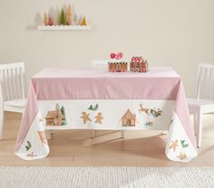 a christmas table with gingerbread houses on it