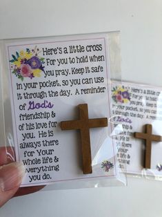 someone is holding up a card with a cross on it and another one has a message