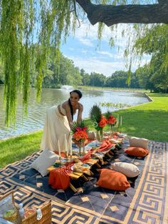 a woman standing next to a table filled with flowers