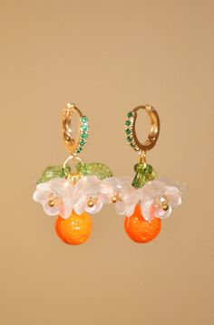 "Positano flower and orange hoop earrings, glass clementine drop earrings, food earrings, fruit earrings, gold summer custom earrings Inspired by Positano in Italy, these lovely little earrings are perfect for giving your outfit a taste of summer. The hoop is a 24k gold-plated earring, studded with small green zircons. Hanging from the hoop are pretty Czech crystal white flowers, green leaves, and at the bottom, an orange, also made of Czech crystal. Floral and fruity, these earrings smell like Summer Orange Jewelry With Fruit Design, Summer Orange Drop Earrings, Summer Orange Flower-shaped Jewelry, Orange Flower-shaped Earrings For Summer, Orange Flower Shaped Earrings For Summer, Peach Earrings For Summer Gift, Orange Fruit Design Earrings As Gift, Earrings Food, Hippie Nails