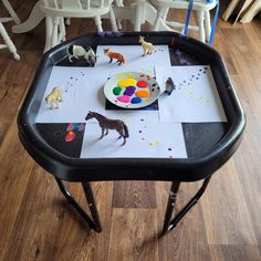 a small table with paint and paper on it