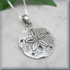 "A beautifully detailed sand dollar pendant is simple and stunning in this beach necklace. This is the perfect necklace for summer! Sterling silver box chain. Pendant is 5/8\" round (1.59 cm). All components are sterling silver. Coordinating earrings for this piece can be found here: https://www.etsy.com/listing/191376144/sanddollar-earrings-sterling-silver-sand?ref=shop_home_active_4 Jewelry is packaged in a cotton lined box for gift-giving. See more Bonny Jewelry at http://bonnyjewelry.etsy.co Beach Pendant Jewelry With Engraving, Beach Engraved Pendant Jewelry, Engraved Pendant Necklace For Beach, Ocean-inspired Round Jewelry With Starfish Charm, Sterling Silver Pendant Jewelry For Beach, Silver Starfish Charm Necklace For Summer, Silver Necklace With Starfish Charm For Summer, Nickel Free Silver Jewelry For The Beach, Nickel-free Silver Jewelry For The Beach