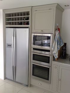 a kitchen with an oven, refrigerator and freezer combination in the middle of it