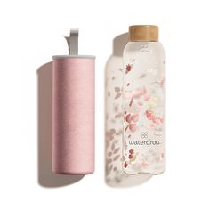 a water bottle next to a roll of toilet paper on a white background with pink flowers