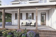 a porch with chairs and flowers in front of it