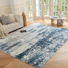 a blue and white rug in a living room