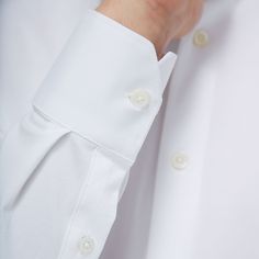 The James solid OoohCotton shirt features a point collar, adjustable notched cuffs, mother-of-pearl buttons, and a curved hem perfect for wearing tucked or untucked. OoohCotton is a performance, double-mercerized, wrinkle-resistant, breathable, and easy-care cotton blend with 8-way stretch, quick-dry, and thermal comfort properties. Classic Blouse With Fold Down Collar And Buttons, Timeless White Button-up Blouse, Classic Tops With Buttons And Fold Down Collar, White Shirt With Hidden Button Closure For Spring, Classic White Blouse With Fold Down Collar, Classic White Blouse With Fold-down Collar, Classic White Tops With Covered Buttons, White Formal Tops With Covered Buttons, Formal White Tops With Covered Buttons