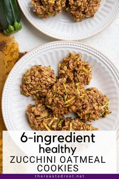 two white plates filled with cookies on top of a wooden table next to zucchini