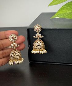 Beautiful CZ Jhumkas earrings for your party wear dresses! Please check the  dimensions of the Jhumkas. Weight of this pair : 1 Oz.  Product care: Avoid contact with Chemicals such as Perfumes or any Sprays. Prevent the Jewellery from the water. Use Butter Paper or Cotton Cloth to store your Jewellery for a longer Product life. Festive Hand Set Jhumkas For Party, Temple Jewelry Style Jhumkas For Party, Temple Jewelry Jhumkas For Party, Temple Jewelry Style Party Jhumkas, Temple Jewelry Style Danglers With Stone Work For Reception, Bollywood Bridal Earrings For Reception With Cutdana, Bollywood Meenakari Pearl Earrings For Reception, Wedding Drop Jhumkas With Latkans, Wedding Jhumkas With Latkans