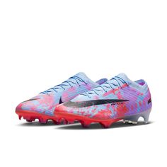 the nike vapor soccer shoe in pink, blue and white with black lettering on it