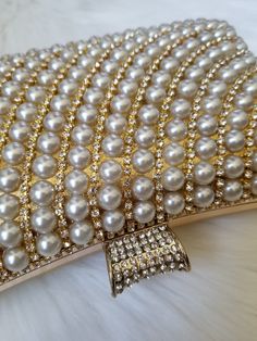 Beautiful Pearl Clutch!! Great for gifts too. Detachable Chain Included Approximate Size: 20 cm (L) x 6 cm (W) x 12 cm (H) Gold Pearl Clutch For Parties, Gold Pearl Party Clutch, Elegant Metal Clutch As A Gift, Elegant Metal Clutch As Gift, Party Gold Pearl Clutch, Luxury Rectangular Clutch With Pearl Embellishments, Glamorous Pearl-embellished Clutch For Gifts, Luxury Beaded Beige Clutch, Gold Rectangular Beaded Clutch