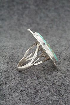 This turquoise and polished-finish sterling silver ring was made by Navajo silversmith Samuel Yellowhair. The back is signed SY and stamped Sterling.Size: 7.75Length: 1 1/4"Width: 1"Free shipping on all orders! We ship with USPS and always include tracking. All orders ship within a day of payment.Returns are accepted up to 30 days after you receive your order. Just send us a message. Our shop offers cash back or store credit. The item must be returned in new condition. Southwestern Polished Turquoise Ring, Southwestern Style Polished Turquoise Ring, Silver Turquoise Ring With Inlay, Adjustable Oval Turquoise Ring With Inlay, Southwestern Polished Turquoise Ring Collectible, Bear Carving, White Buffalo, Pearl Chain, Native American Jewelry