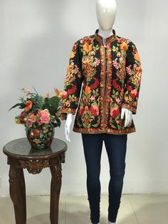 Get a polished look with this jacket. Pair it up with a skirt, trousers, dress or even a flowing maxi and be ready in style.Product Details- Condition: Brand New (made to order)- Handmade- Style: Short Jacket- Fabric: Art Raw Silk- Embroidery: Kashmiri Aari Embroidery- Base Color: Black- Embroidery Color: Multi-Color- Fully Lined from Inside- Features Pockets on both sides- Length: 27.5" (70 cm approx)- Care Instructions: Dry Clean OnlySizing- You can just leave your measurements in checkout not Indian Jackets, Skirt Trousers, Bohemian Jackets, Jacket Fabric, Aari Embroidery, Black Embroidery, Floral Jacket, Silk Jacket, Work Jackets