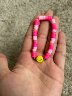 Made with durable string this bracelet is very pink and cheery. This smiley face is going to keep a smile on your face. Fair warning the black may fade overtime with exposure to water. Pink Smiley Face Jewelry For Everyday, Adjustable Pink Jewelry With Smiley Face, Trendy Pink Smiley Face Jewelry, Adjustable Smiley Face Fun Bracelet, Playful Pink Bracelets For Everyday, Playful Pink Bracelet For Everyday, Pink Smiley Face Round Bead Jewelry, Pink Cheerful Friendship Bracelets, Pink Smiley Face Round Beaded Jewelry