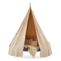 a teepee tent with pillows in it and a stuffed animal hanging from the ceiling