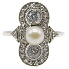 Charming Art-Deco 14 karat white gold diamond and pearl ring, centrally set with one white round pearl and flanked by 2 Old European Cut diamonds. Surrounding these, in a mill-grain bezel are 24 rose cut diamonds and another rose cut diamond on the top of each shank. Size 7.5. Can be resized Item Number O575 Diamond And Pearl Ring, Pearl Gold Ring, Art Deco Pearl, Antique Rings Victorian, Art Nouveau Ring, Pearl Engagement Ring, Art Deco Diamond Rings, Vintage Diamond Rings, Citrine Ring