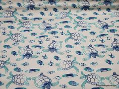 a blue and white fabric with sea turtles on it