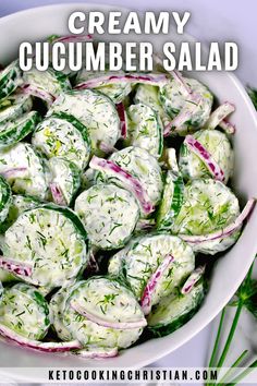 a white bowl filled with cucumber salad on top of a table