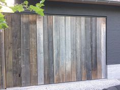 a wooden garage door sitting on the side of a building